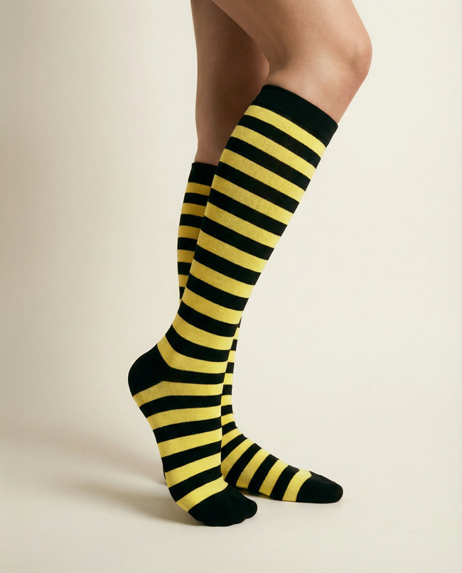 Black and yellow striped knee-high socks on a neutral background