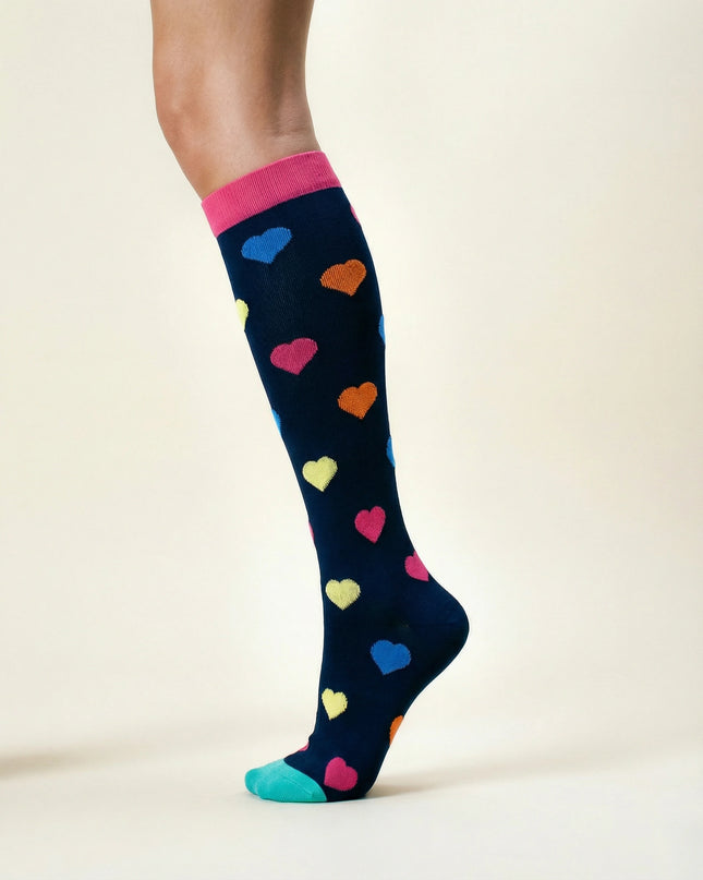 Navy sock with colorful heart patterns worn by a person on a beige background