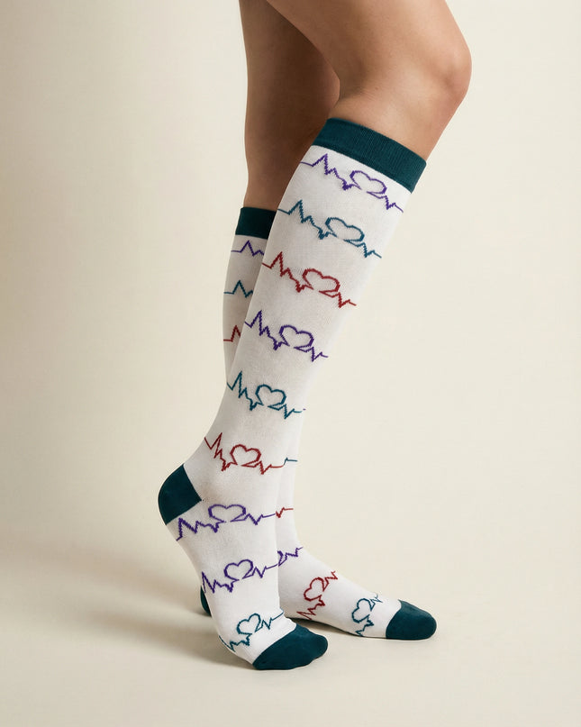 White socks with colorful heart and line pattern worn by a person on a beige background