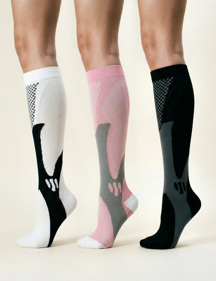 Three pairs of compression socks in white, pink, and black on a neutral background