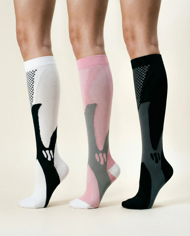 Three pairs of compression socks in white, pink, and black on a neutral background
