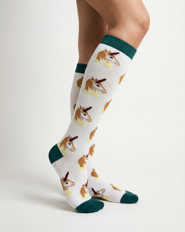 White knee-high socks with kangaroo pattern worn by a person on a light gray background