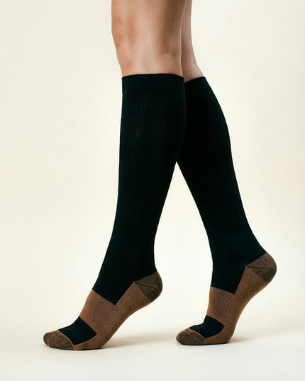 Black knee-high socks with brown accents worn by a person on a white background