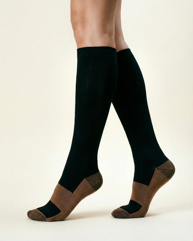 Black knee-high socks with brown accents worn by a person on a white background