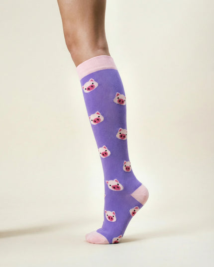 Purple knee-high socks with bear pattern worn by a person on a light background