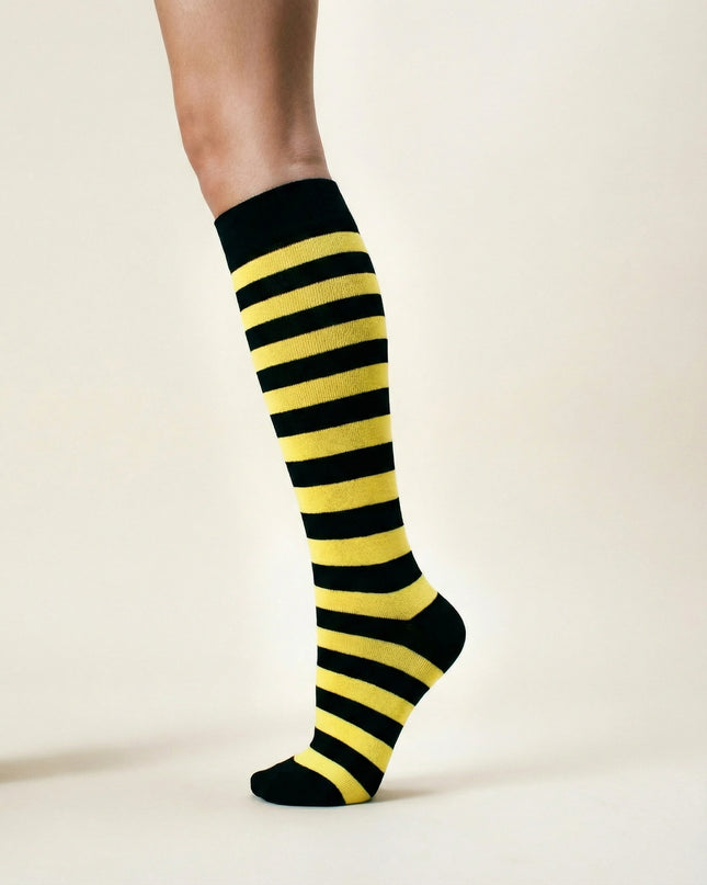 Black and yellow striped knee-high socks on a neutral background