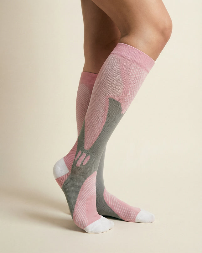 Pink and gray compression socks on a beige background