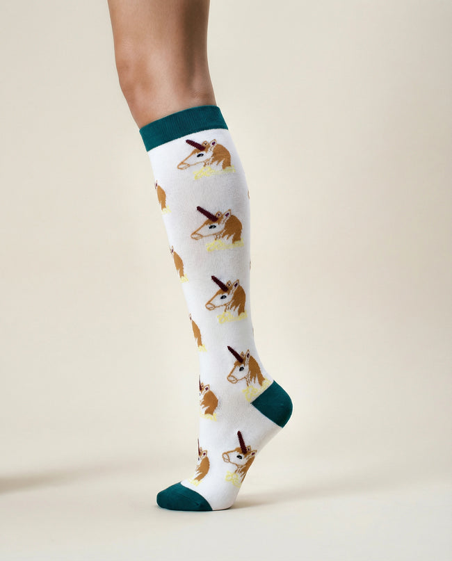 Knee-high socks with dog pattern worn by a person on a beige background