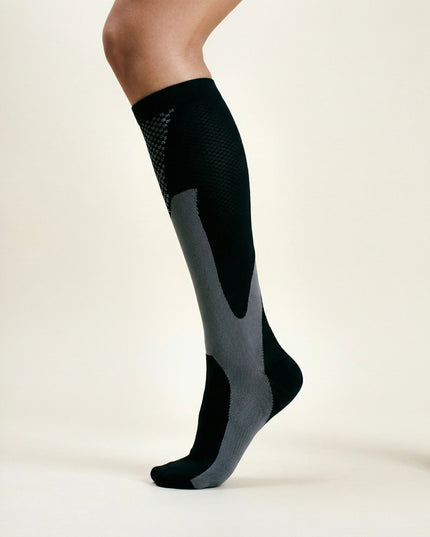 Black knee-high sock on a white background