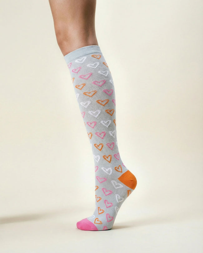 Knee-high sock with heart pattern on a light background