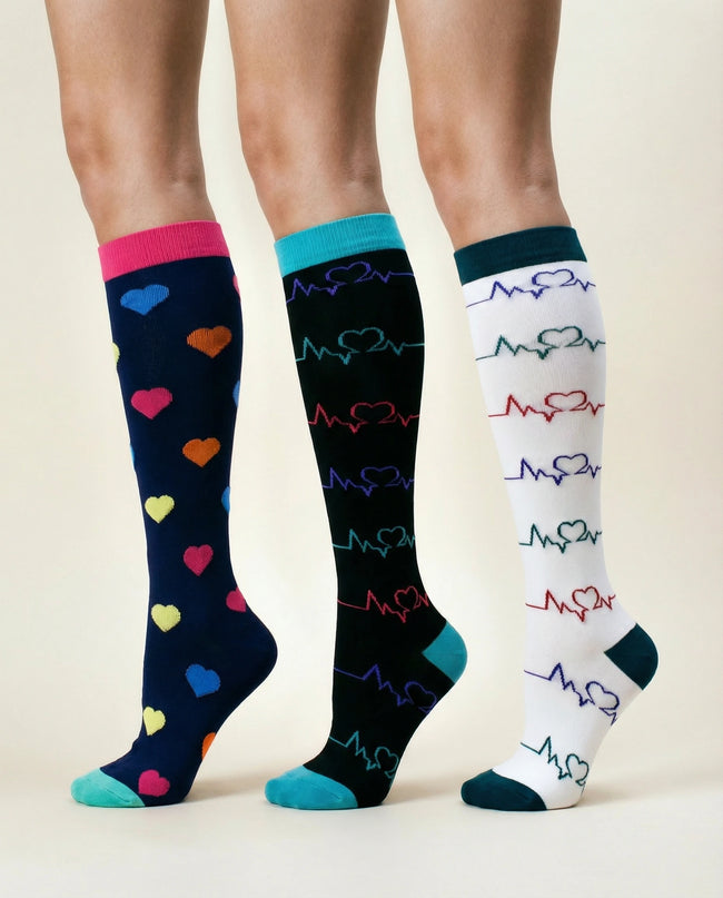 Three pairs of knee-high socks with heart and heartbeat pattern on a beige background