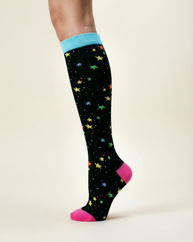 Knee-high sock with colorful star pattern on a plain background