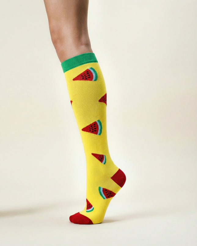 Yellow knee-high socks with watermelon pattern on a light background
