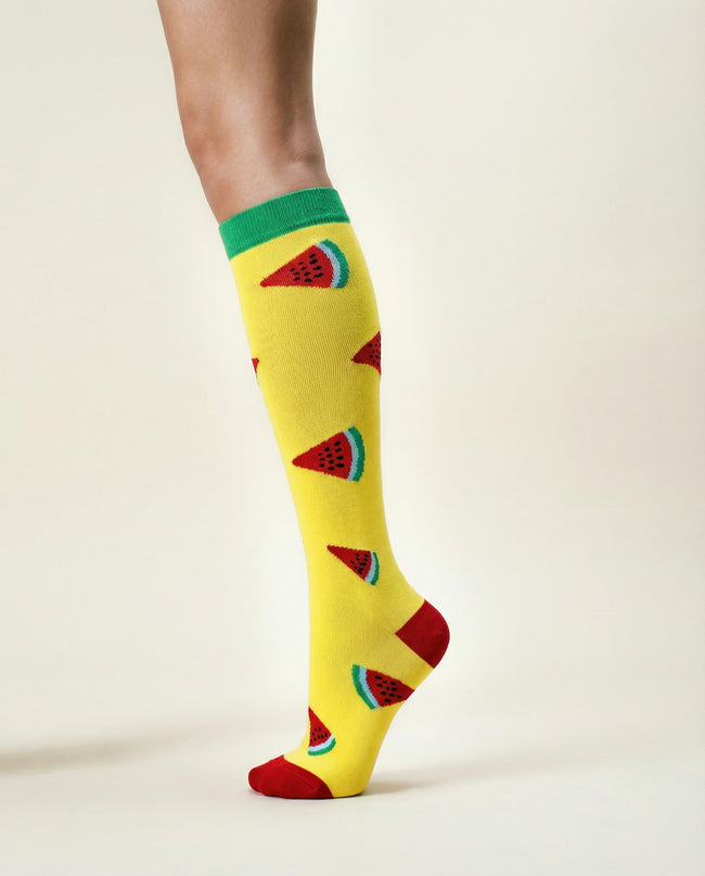 Yellow knee-high socks with watermelon pattern on a light background