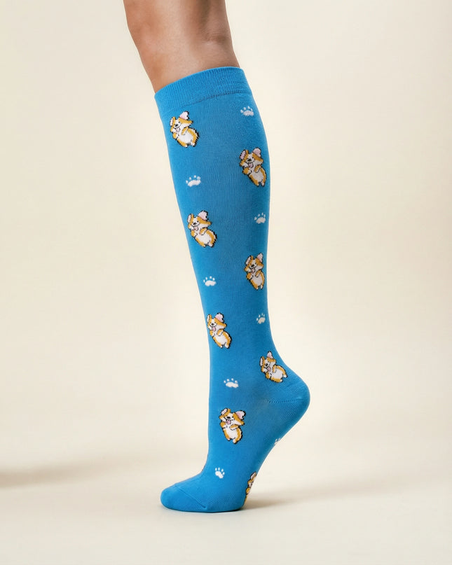 Blue knee-high socks with teddy bear pattern on a beige background